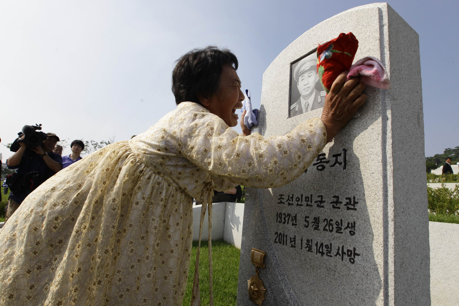 A North Korean woman Kim Bu-ok cries as she mourns her father in Pyongyang
