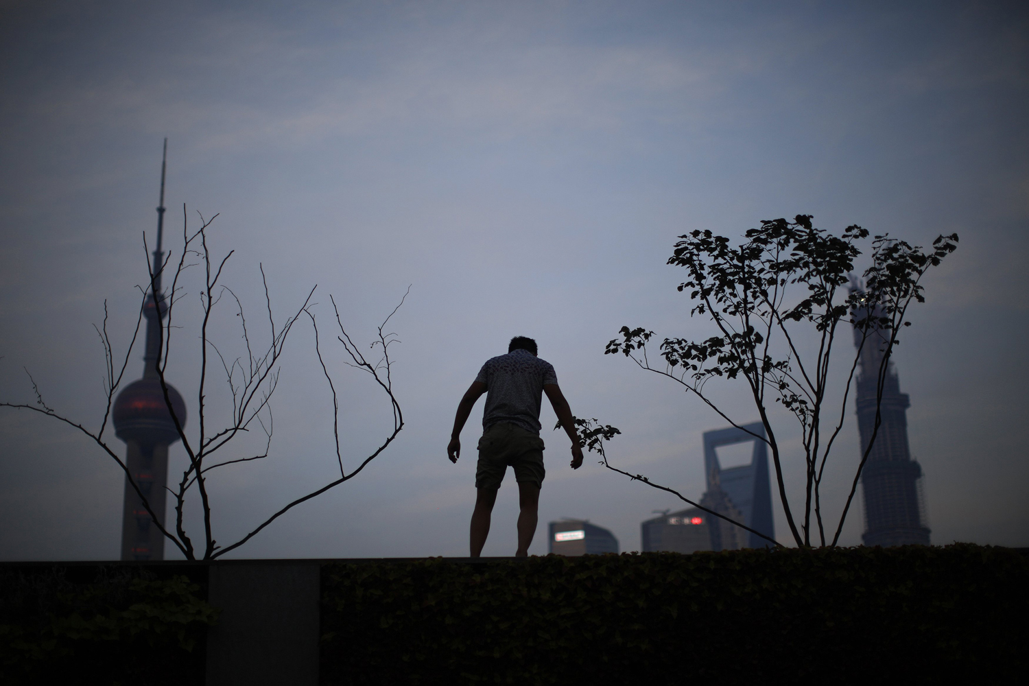Man stands at Bund in front of the financial district of Pudong, in downtown Shanghai