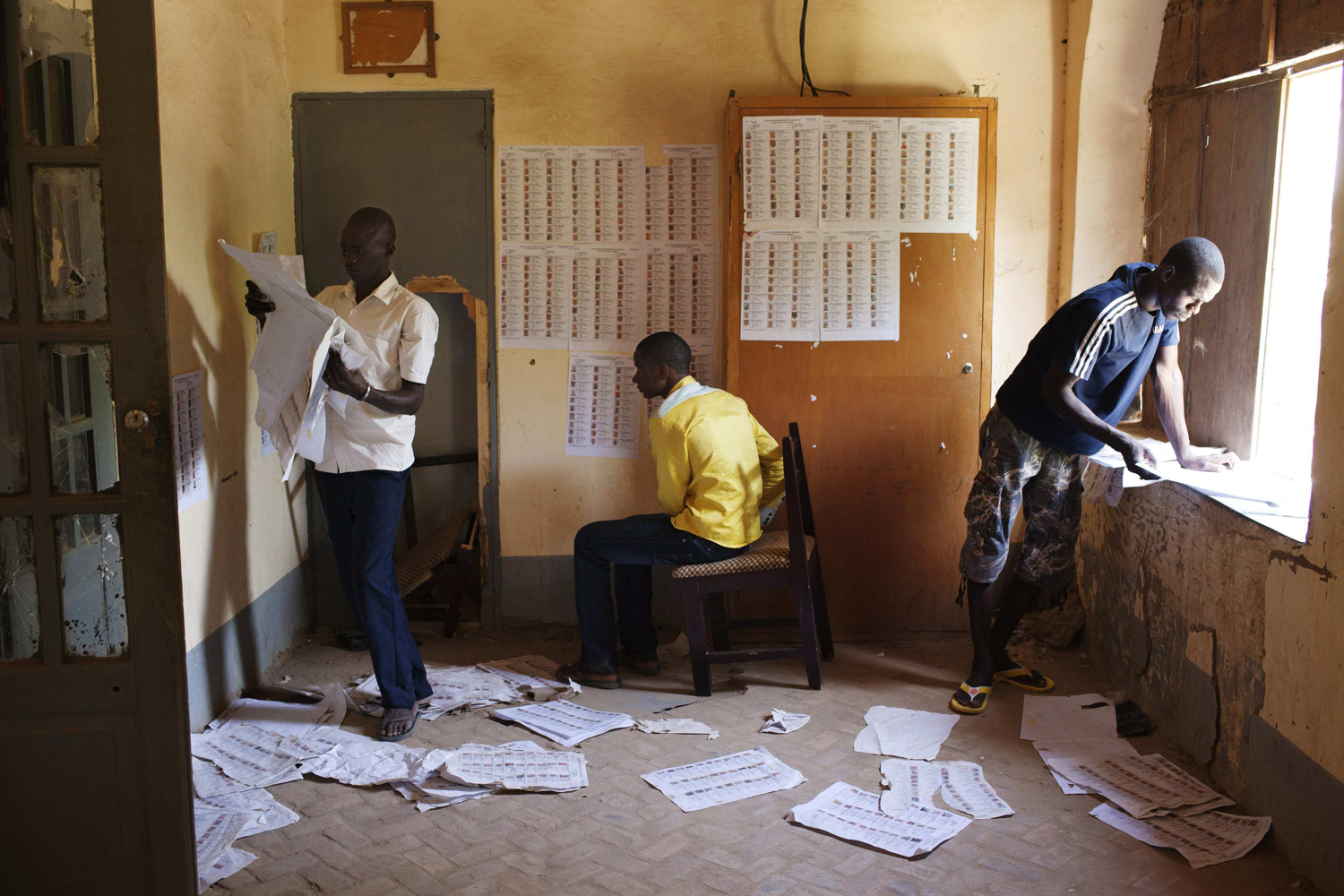 People search for their names on lists that indicate where to vote, in Timbuktu