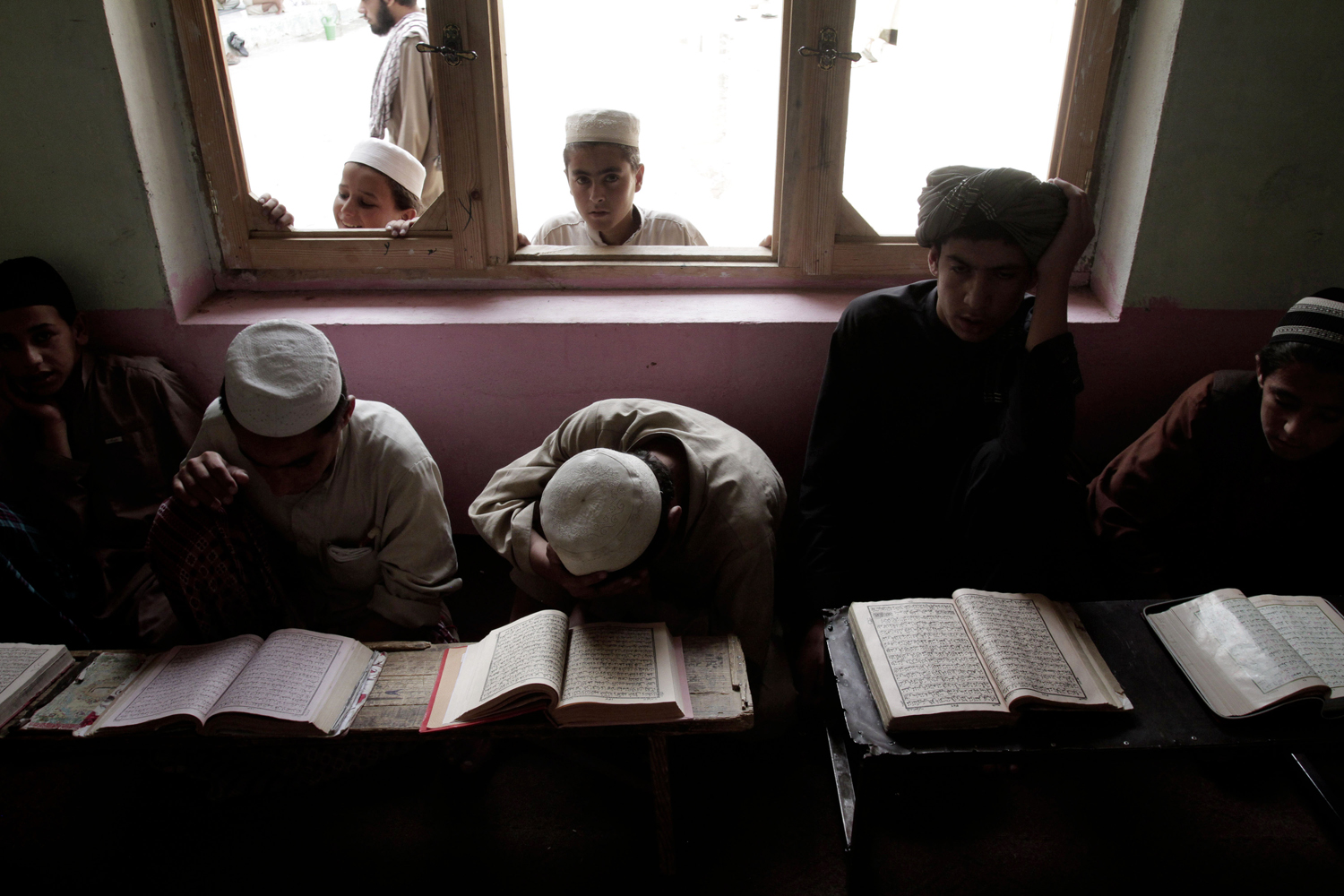 July 16, 2013. Afghan boys read the Quran during the Muslim holy month of Ramadan at a mosque on the outskirts of Kabul.