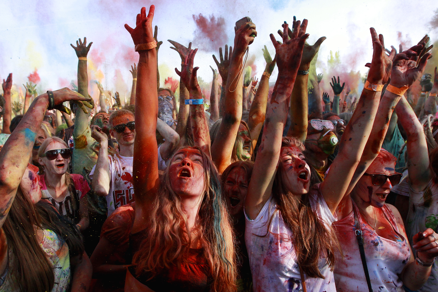 July 13, 2013. Young people throw colored powders at each other during the 'Festival of Colors' in St. Petersburg, Russia.