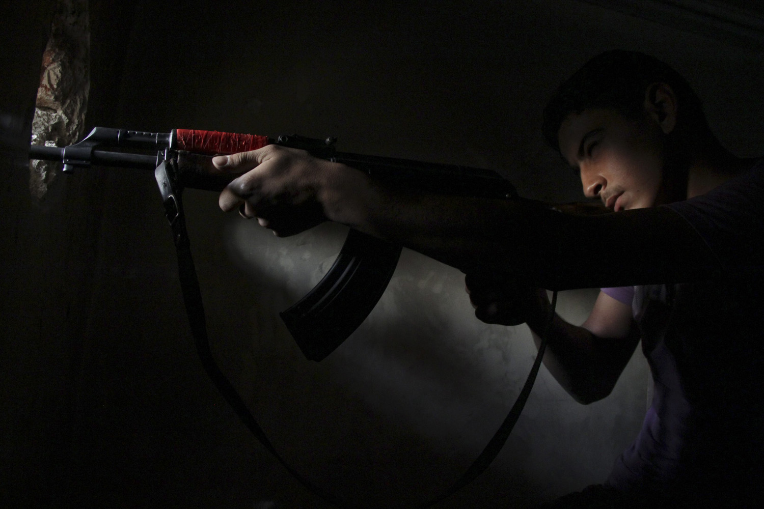 A Free Syrian Army fighter takes up a shooting position in Aleppo