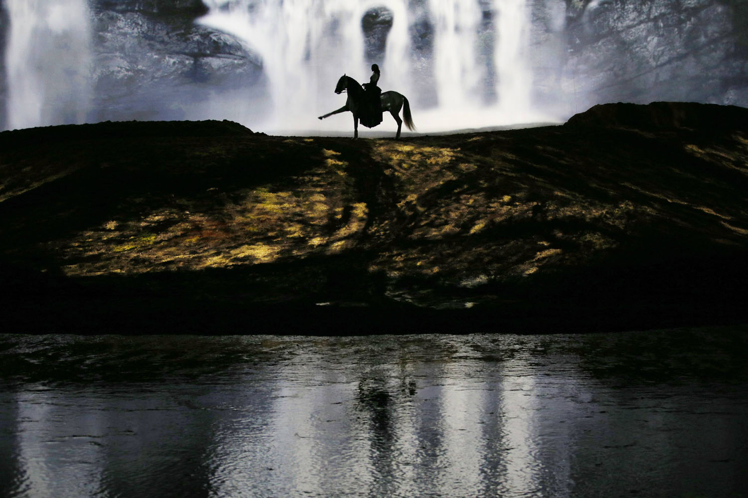 A horse and rider perform during a "sneak peek" performance of Cavalia's show "Odysseo" in Somerville