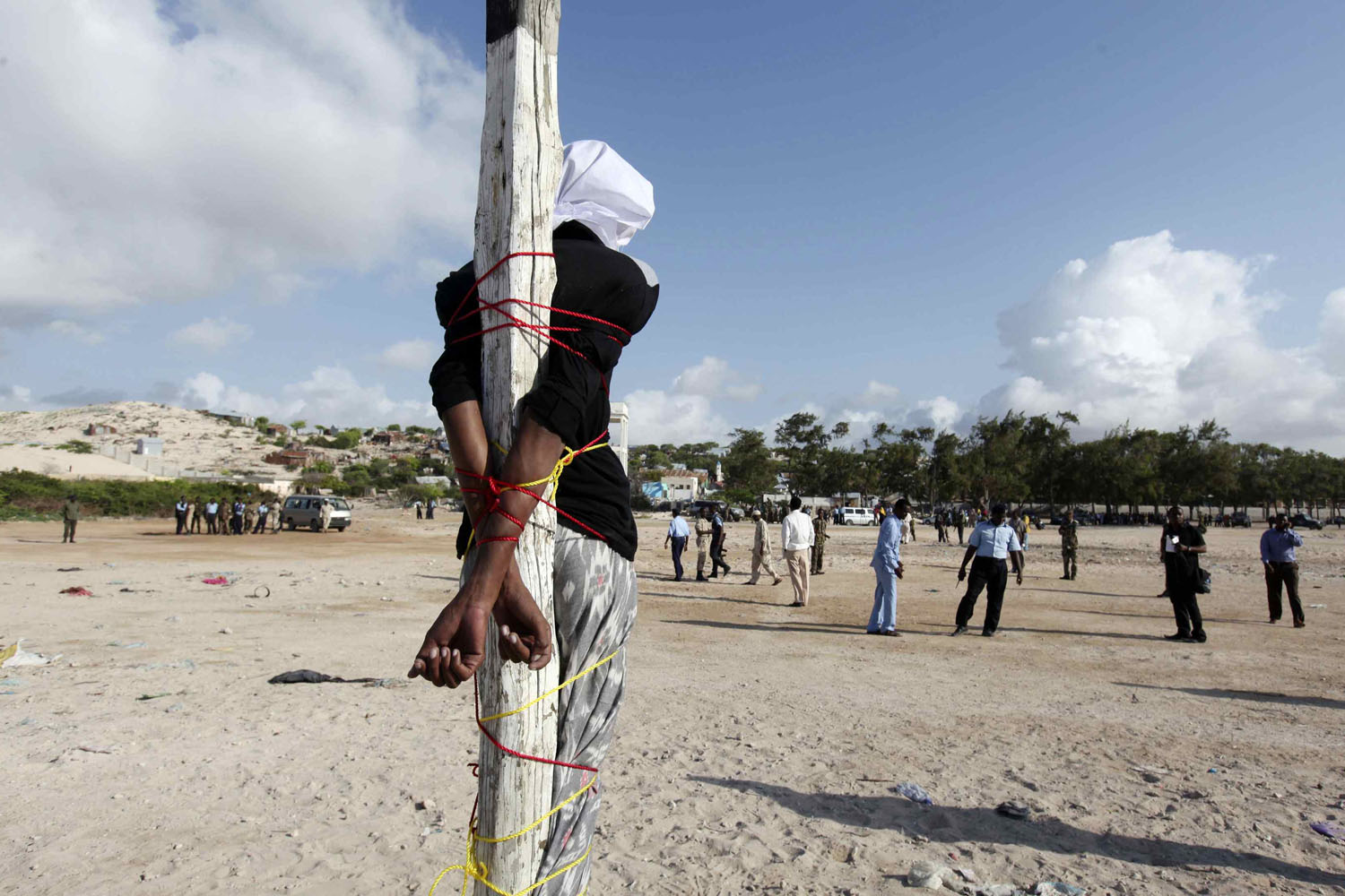 Abdi Sheikh, who has been sentenced to death for the murder of journalist Absuge, stands tied to a pole before he is executed by shooting at close range in Mogadishu
