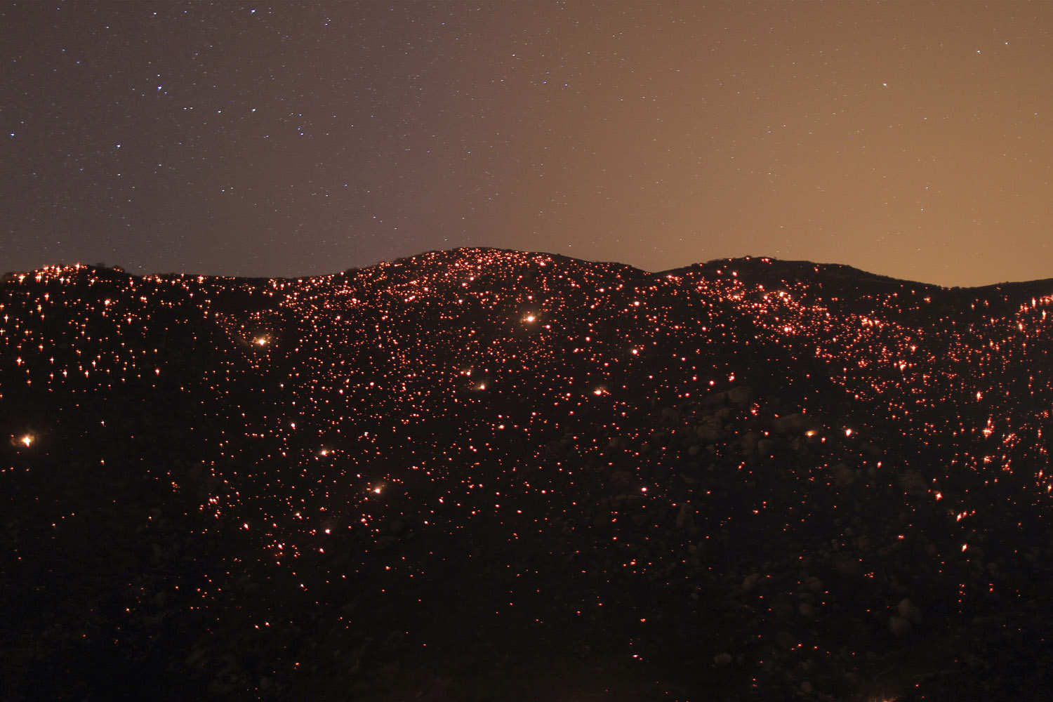 A smouldering mountainside is seen under the stars at the Silver Fire near Banning