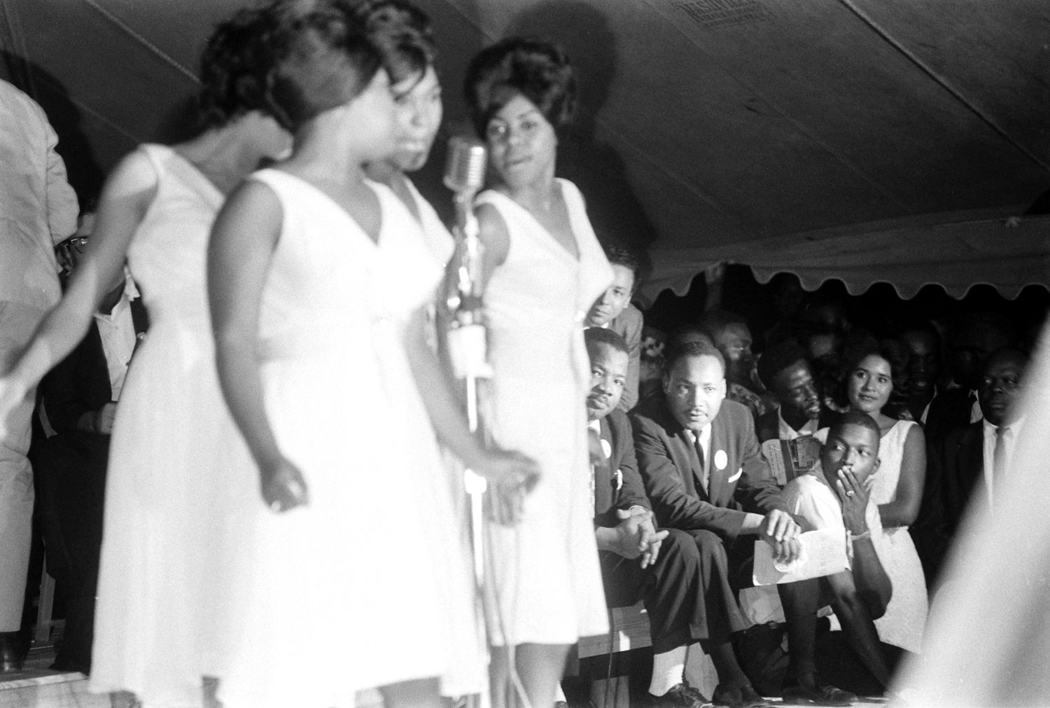 Martin Luther King Jr. (seated, at right) watches the Shirelles perform during the Salute to Freedom benefit concert in Birmingham, Ala., August 5, 1963.