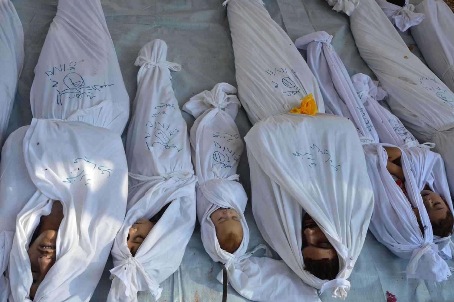 Bodies of people activists say were killed by nerve gas in the Ghouta region are seen in the Duma neighbourhood of Damascus