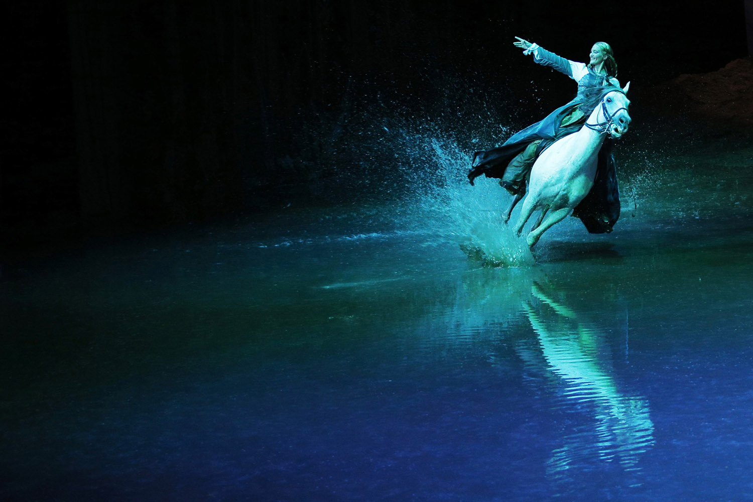 Horses and rider Elise Verdoncq perform during a "sneak peek" performance of Cavalia's show "Odysseo" in Somerville