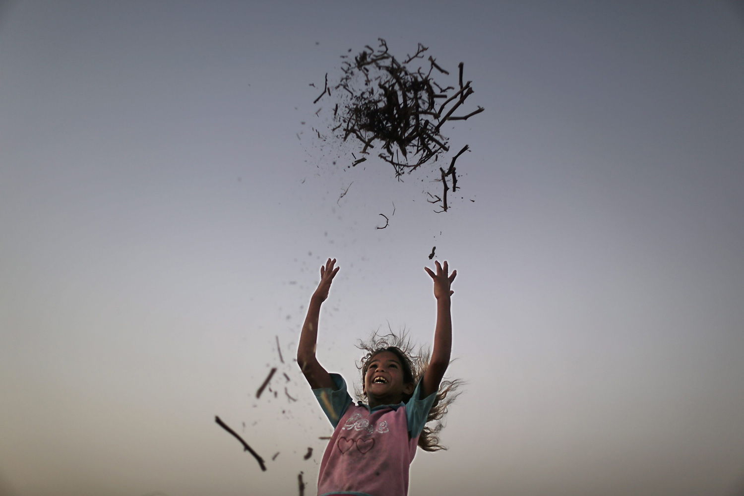 A Palestinian girl play outside her family's tent in a poverty-stricken quarter of the town of Younis