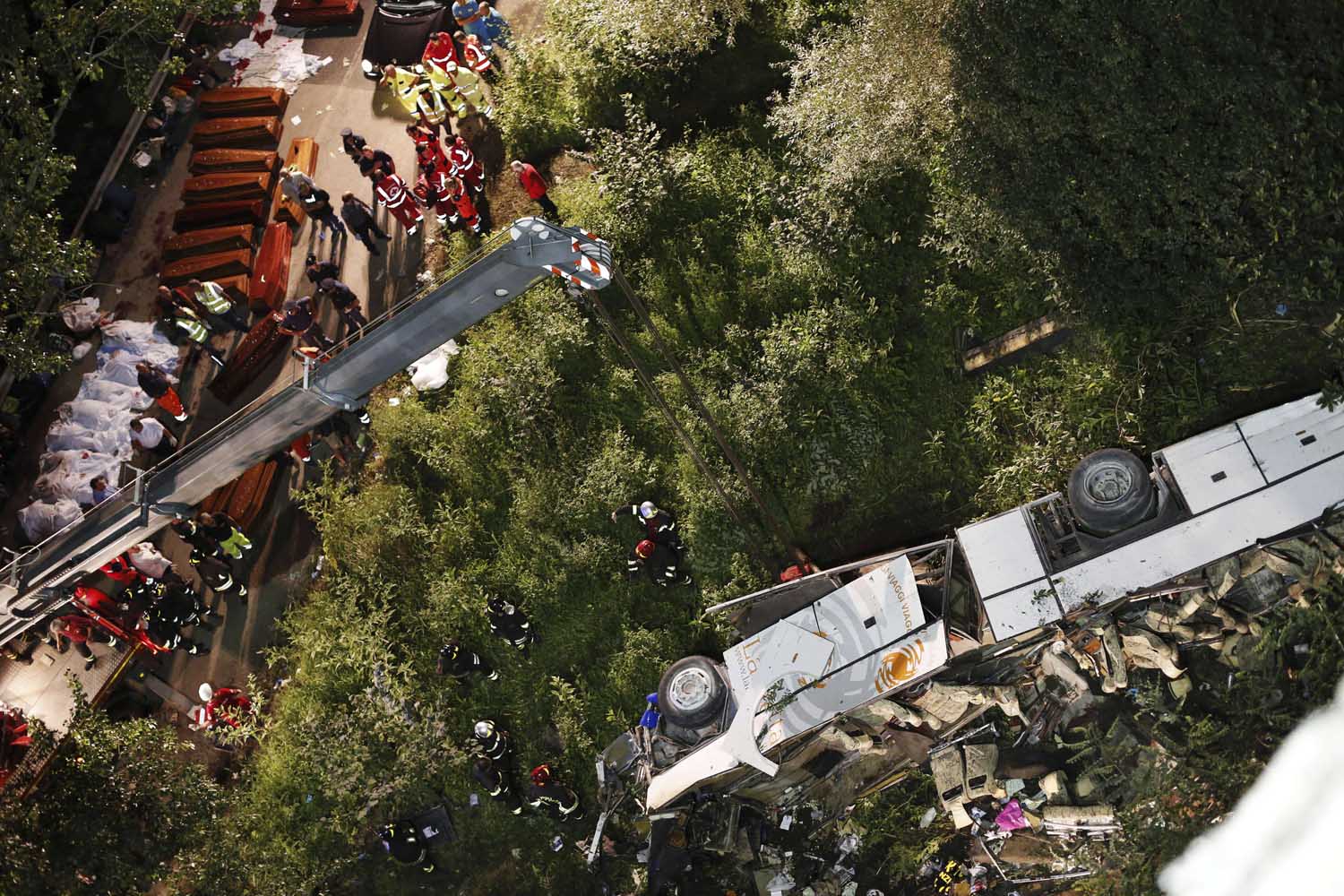 July 28, 2013. Rescuers prepare the coffins of victims of a bus crash on the road between Monteforte Irpino and Baiano, southern Italy.