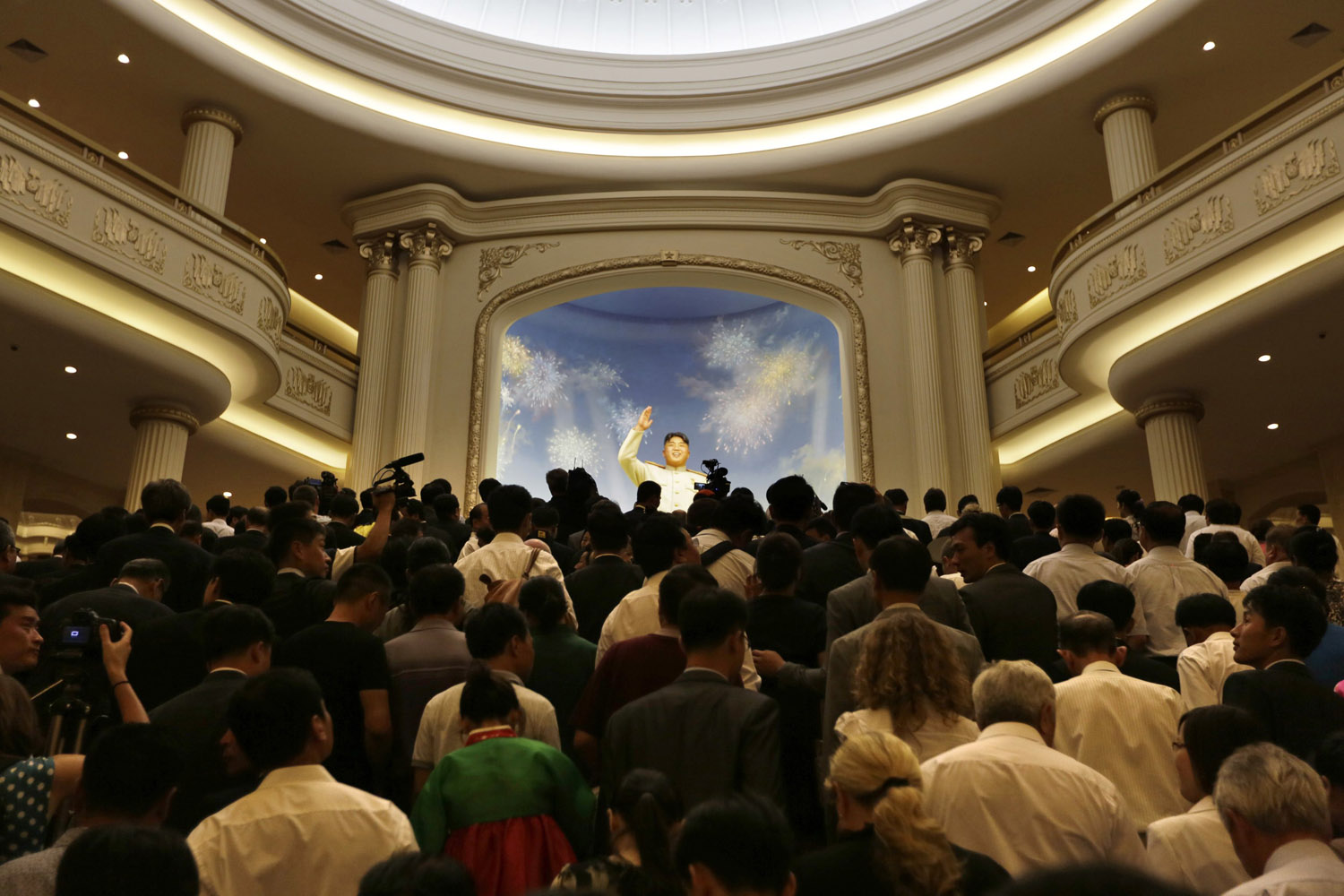 July 27, 2013. North Koreans and the media arrive to visit in front of a figure of North Korea founder Kim Il-sung after the opening ceremony of the Victorious Fatherland Liberation War Museum, in Pyongyang as part of celebrations of the 60th anniversary of the signing of a truce in the 1950-1953 Korean War.