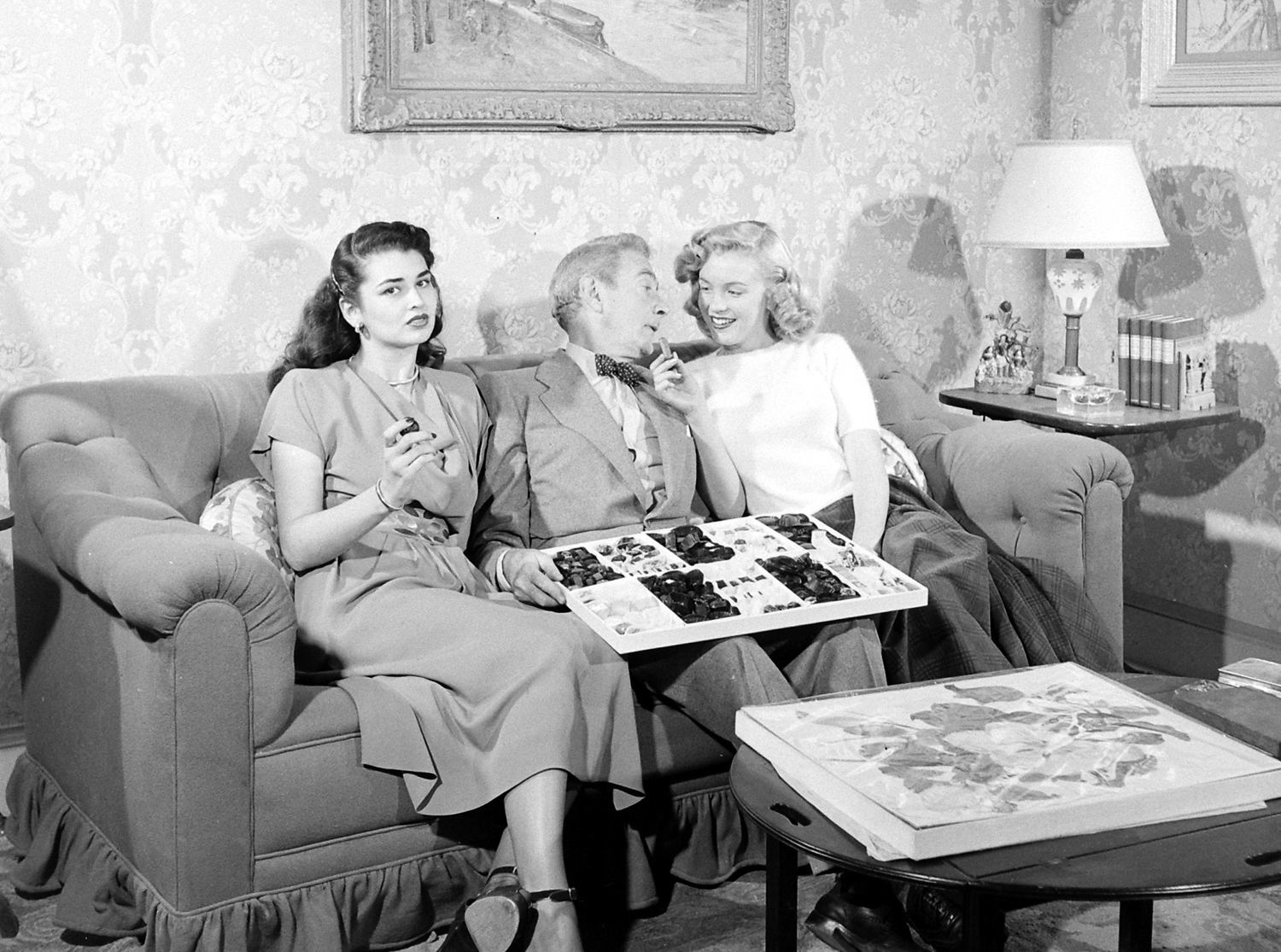 Then-unknown actress Marilyn Monroe with Clifton Webb and Laurette Luez on the set of a 1948 comedy, "Sitting Pretty."
