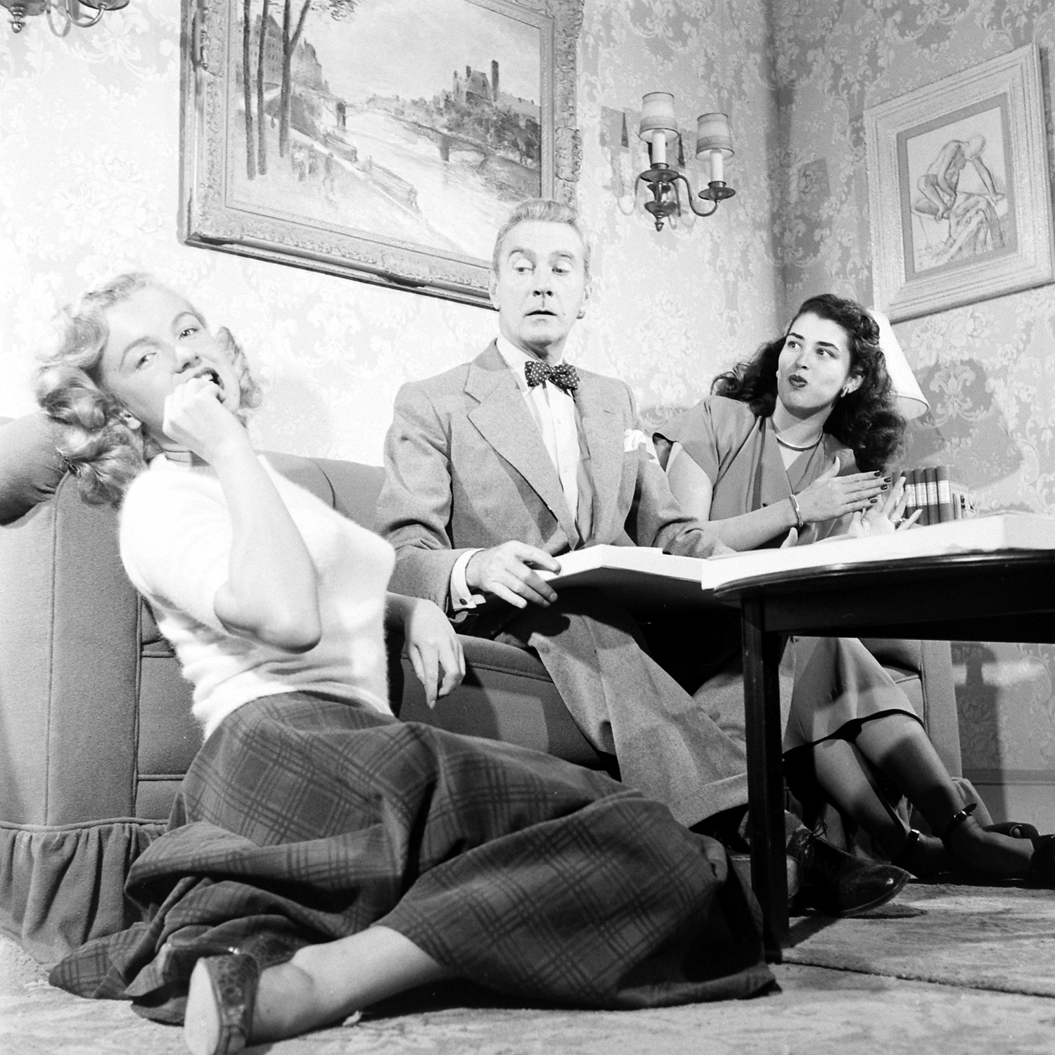 Then-unknown actress Marilyn Monroe with Clifton Webb and Laurette Luez on the set of a 1948 comedy, "Sitting Pretty."