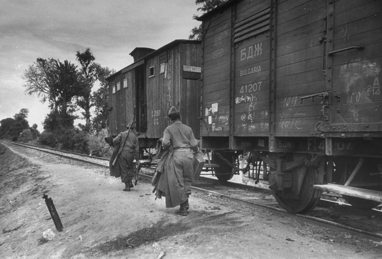 Greek soldiers board boxcars at Svilengrad to guard train against Communist marauders who sneak across border from Bulgaria to join Red guerillas in Greece.