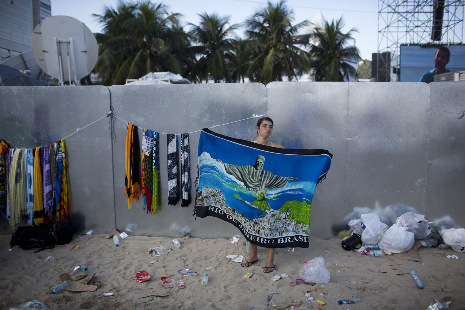 July 28, 2013. A street vendor sells a beach blanket with an image of Christ the Redeemer statue after the World Youth Day's closing Mass, celebrated by Pope Francis on the Copacabana beachfront in Rio de Janeiro, Brazil.