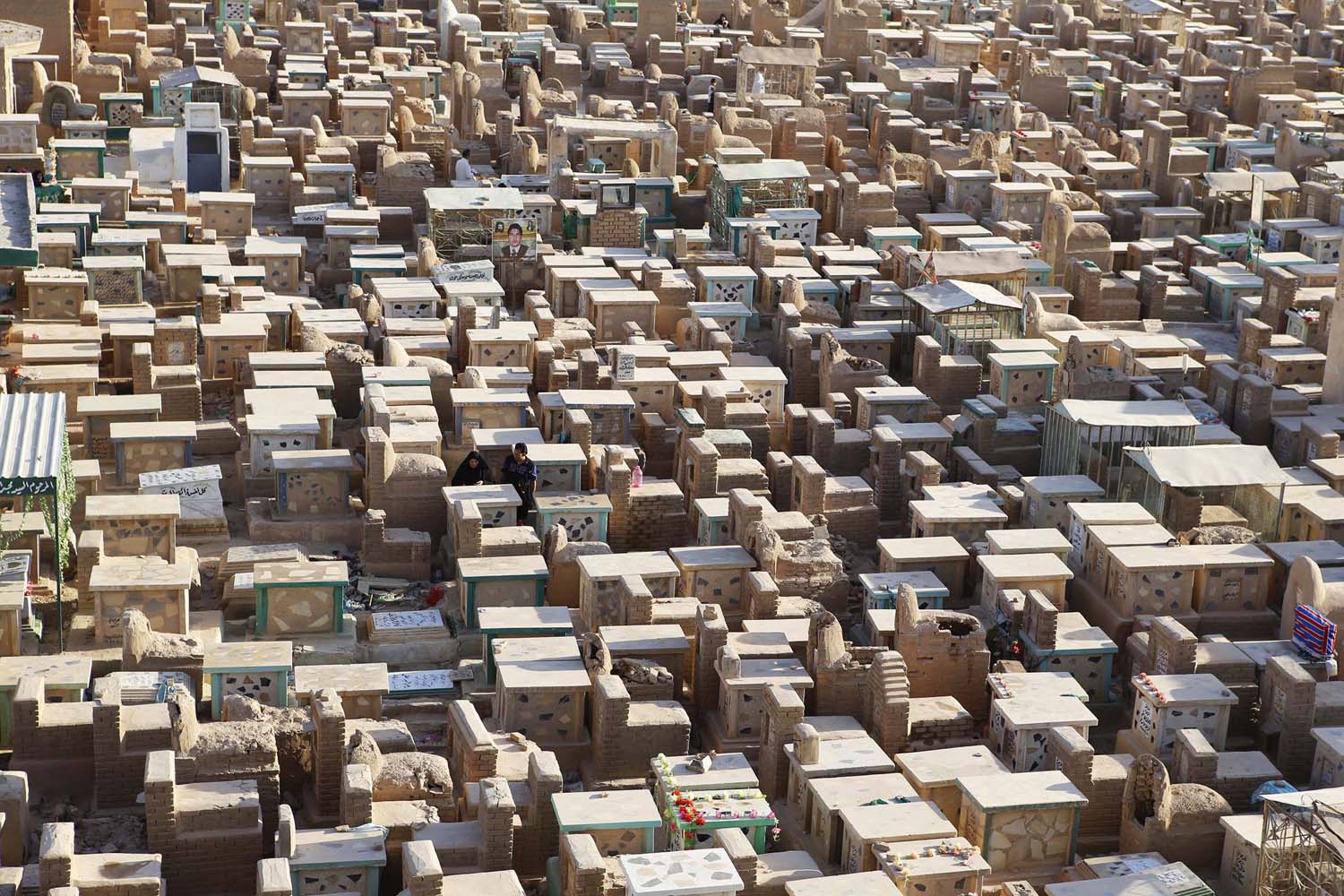 People visit the "Valley of Peace" cemetery during the first day of the Eid al-Fitr in Najaf