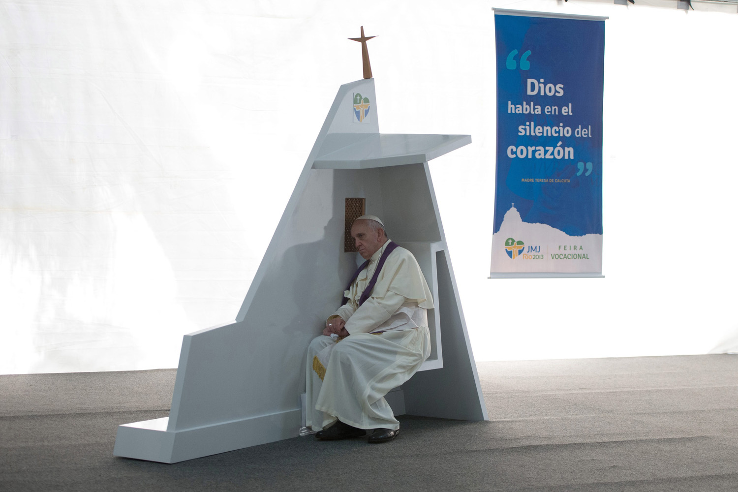 July 26, 2013. A handout photo made available by the Vatican newspaper Osservatore Romano shows Pope Francis (R) hearing confessions of young people in the park of Quinta Da Boa Vista in Rio de Janeiro in Brazil.