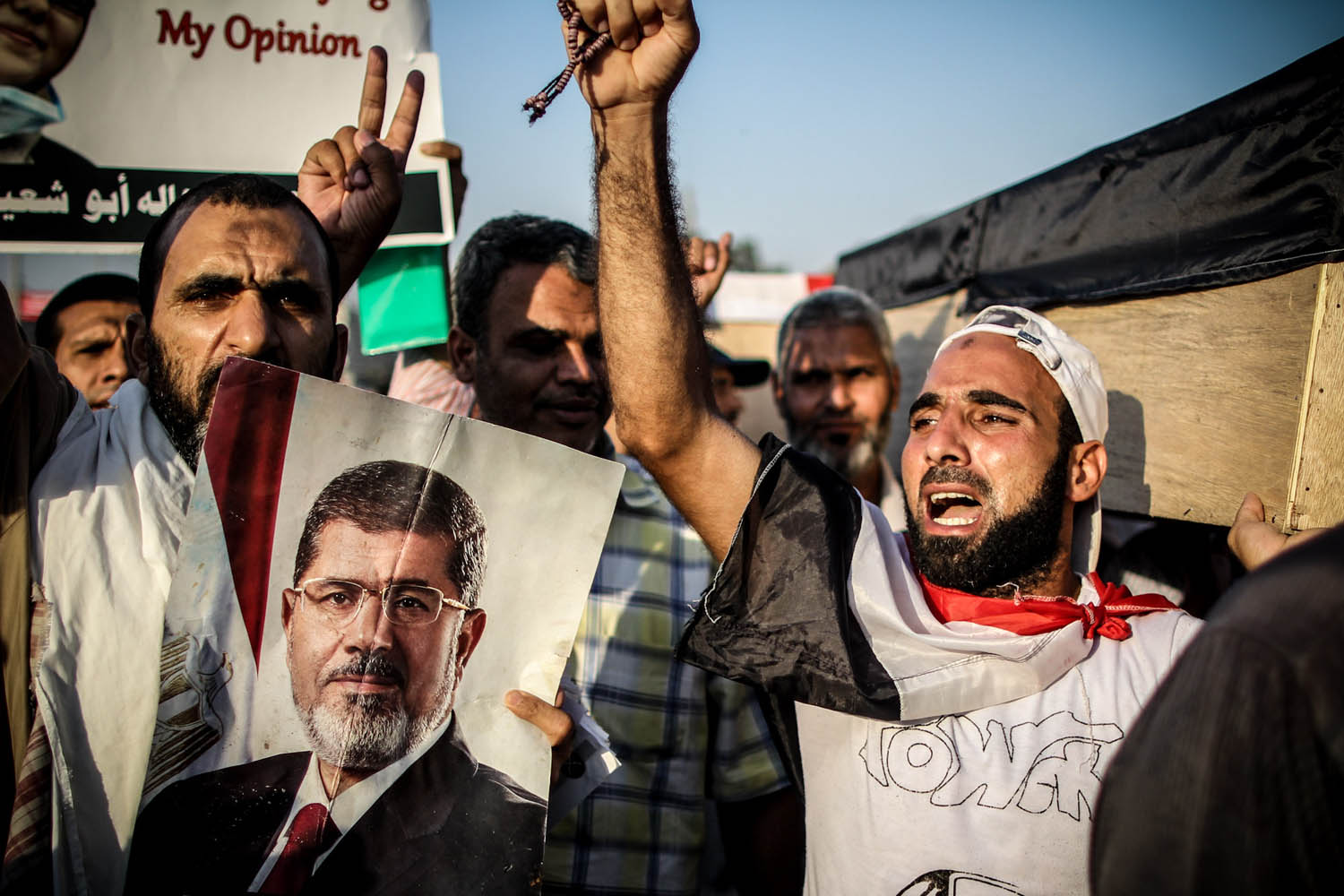 July 30, 2013. Morsi supporters chant for justice as they carry symbolic coffins of the victims of the Rabaa massacre. Tuesday saw big demonstrations against the coup after calls for a million man march in honor of Sunday's victims.