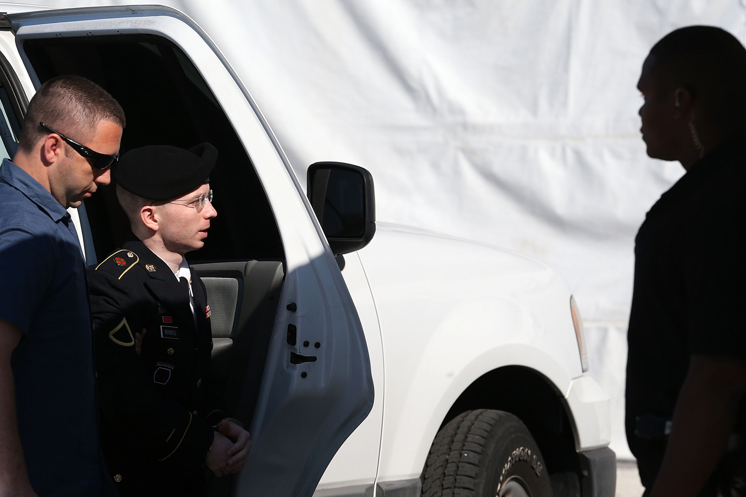July 30, 2013. U.S. Army Private First Class Bradley Manning (C) is escorted by military police as arrives to hear the verdict in his military trial at Fort George G. Meade, Maryland.