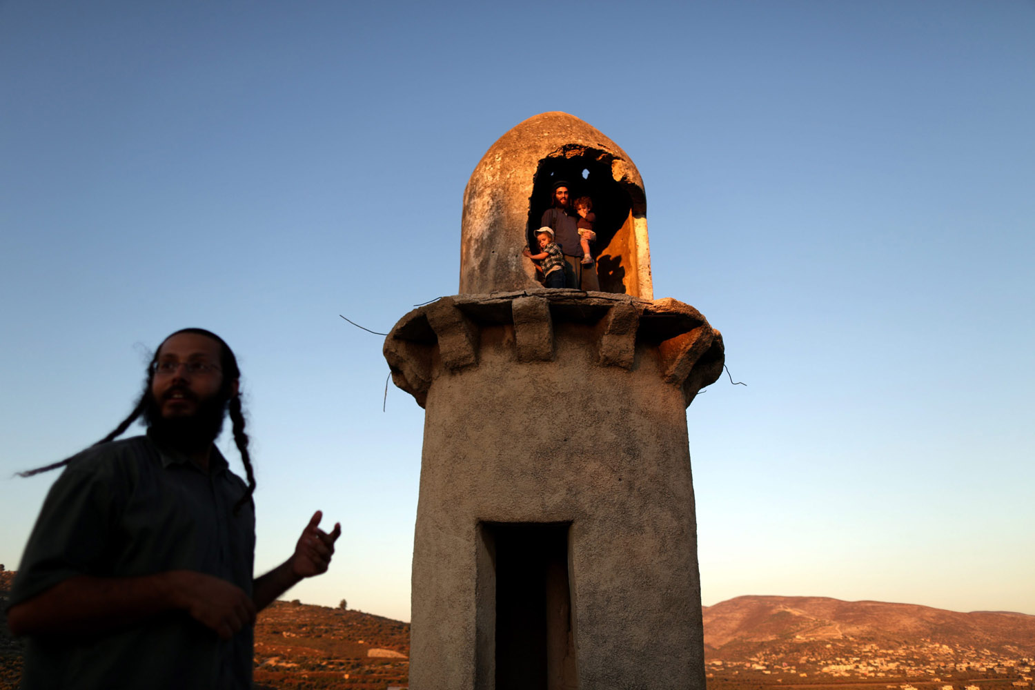July 28, 2013. A Jewish settlers in a minaret of an ancient mosque at the former settlement of Sanur in northern Samaria, near the West Bank city of Jenin.