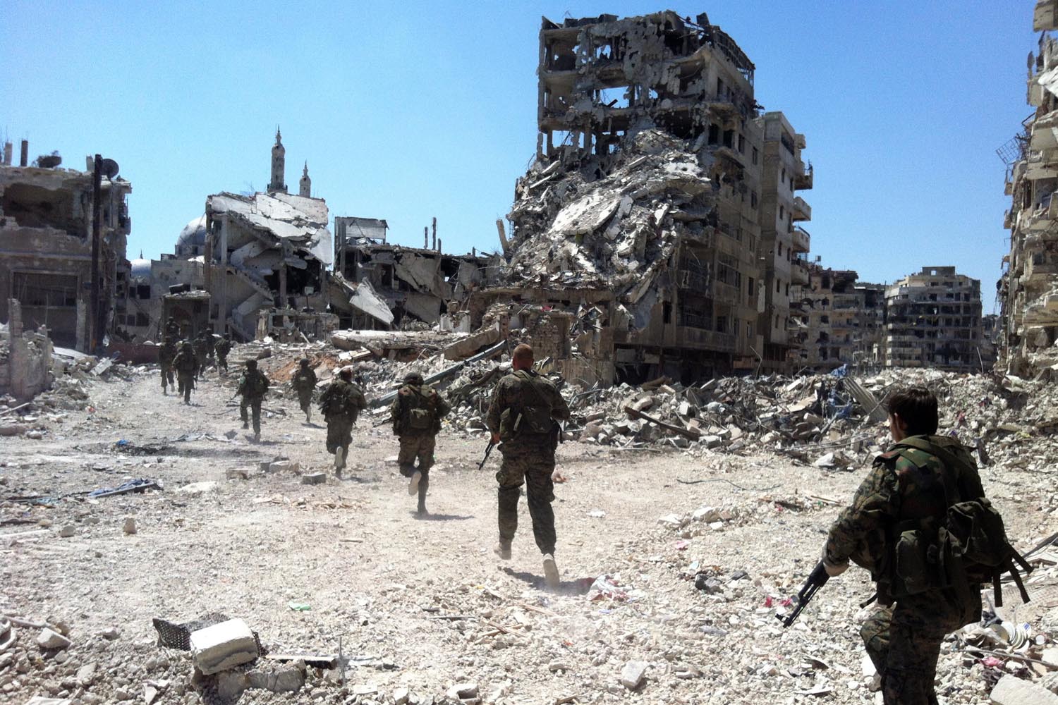 July 28, 2013. Syrian government forces patrol in the Khalidiyah neighborhood of the central city of Homs.