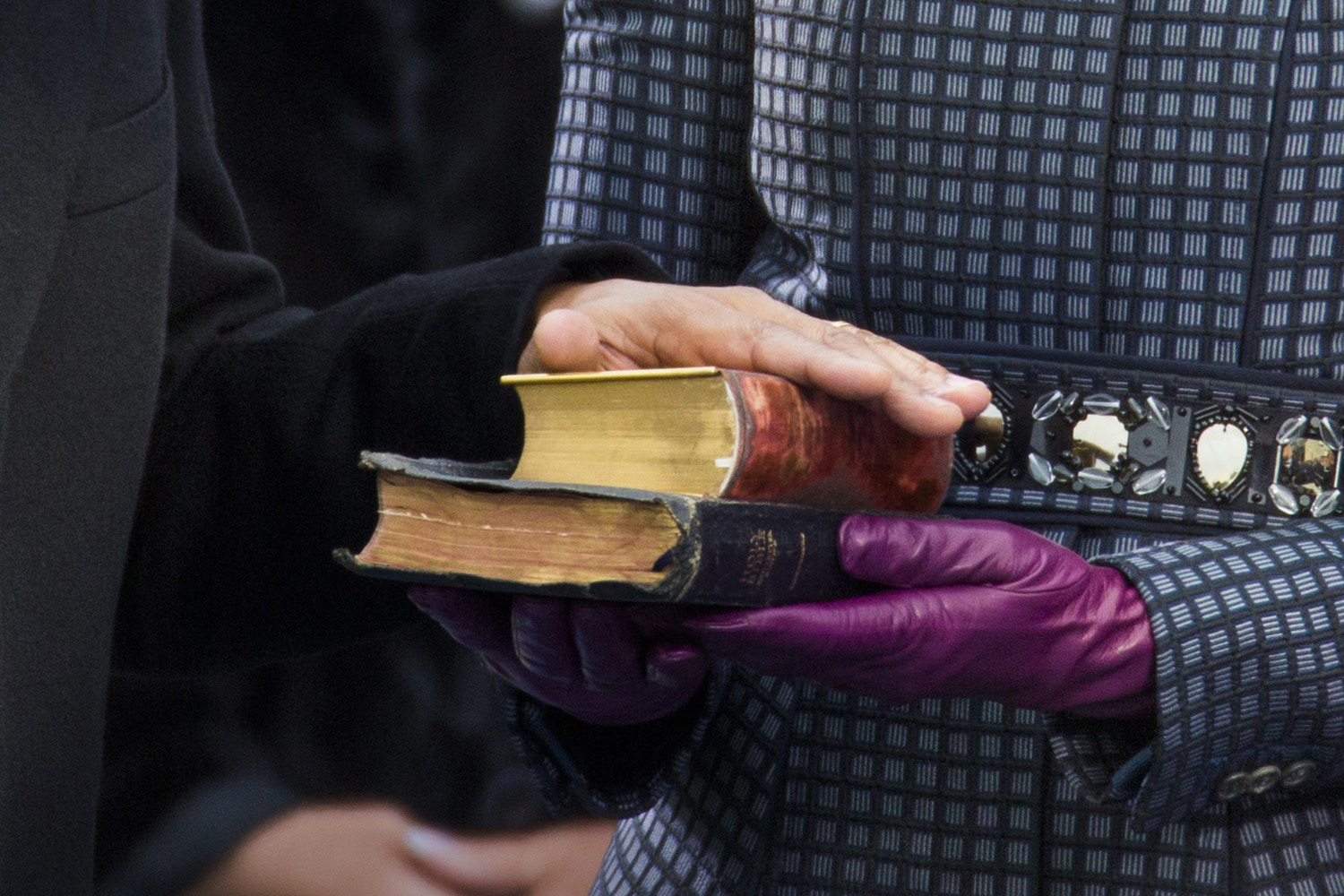 U.S. President Barack Obama places his hand on two bibles as held by first lady Michelle Obama as his recites the oath of office during swearing-in ceremonies on the West front of the U.S Capitol in Washington.  The first is the Bible used by former President Abraham Lincoln,  when he took the oath of office in 1861.  The second Bible is the so-called "traveling Bible" used by slain civil rights leader Martin Luther King, Jr.