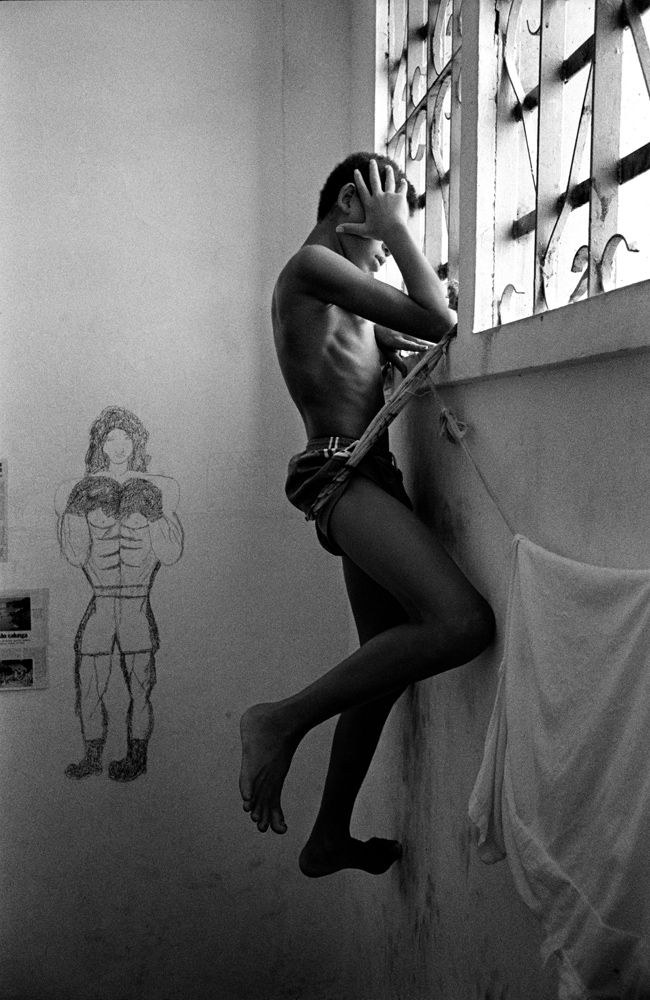 Salvador de Bahia, Brazil. 1993. At the window in the reformatory. This boy tried to stab another child for stealing his sneakers.