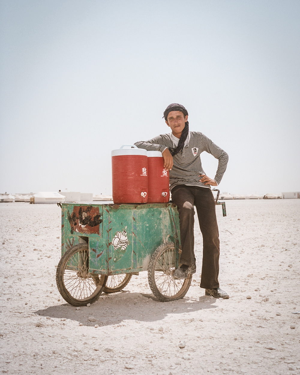 Nadeem Musallam, 17, from Dara'a, Syria, sells juice on the baren outskirts of Zaatari.