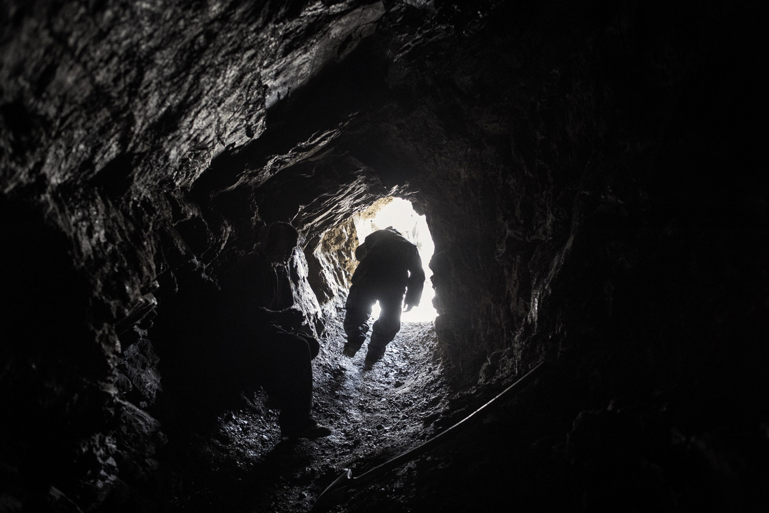 Panjshir Valley in north-central Afghanistan May 2013: A worker emerges from an emerald mine. After explosives are set off in the rocks, miners use large plastic tubes to draw out dust and smoke so they can go back in to work.