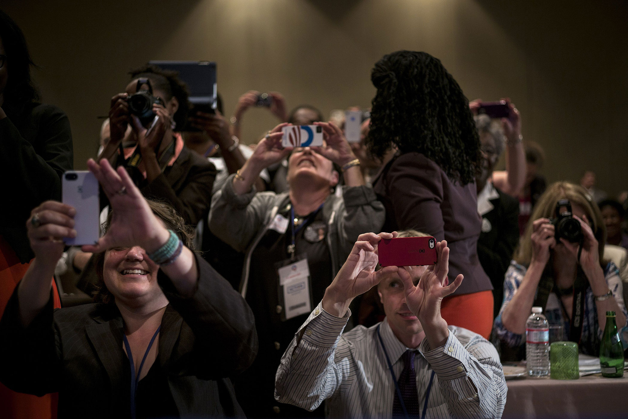 Supporters take photos while President Barack Obama speaks to members of Organizing for Action at the Mandarin Oriental Hotel in Washington, July 22, 2013.