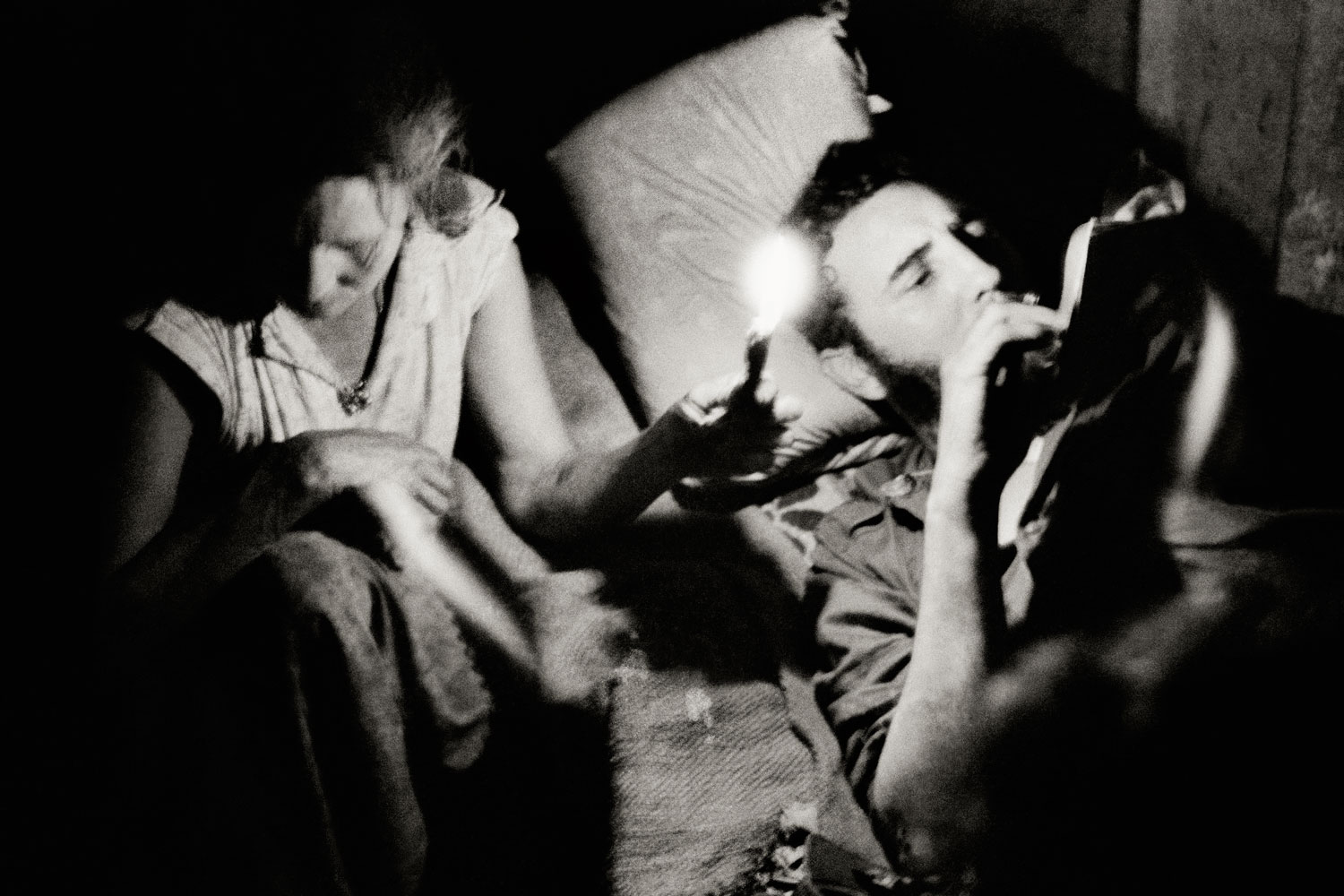 Fidel Castro reads at night during the Battle of Pino del Agua, in the Sierra Maestra mountains, Cuba, 1958.