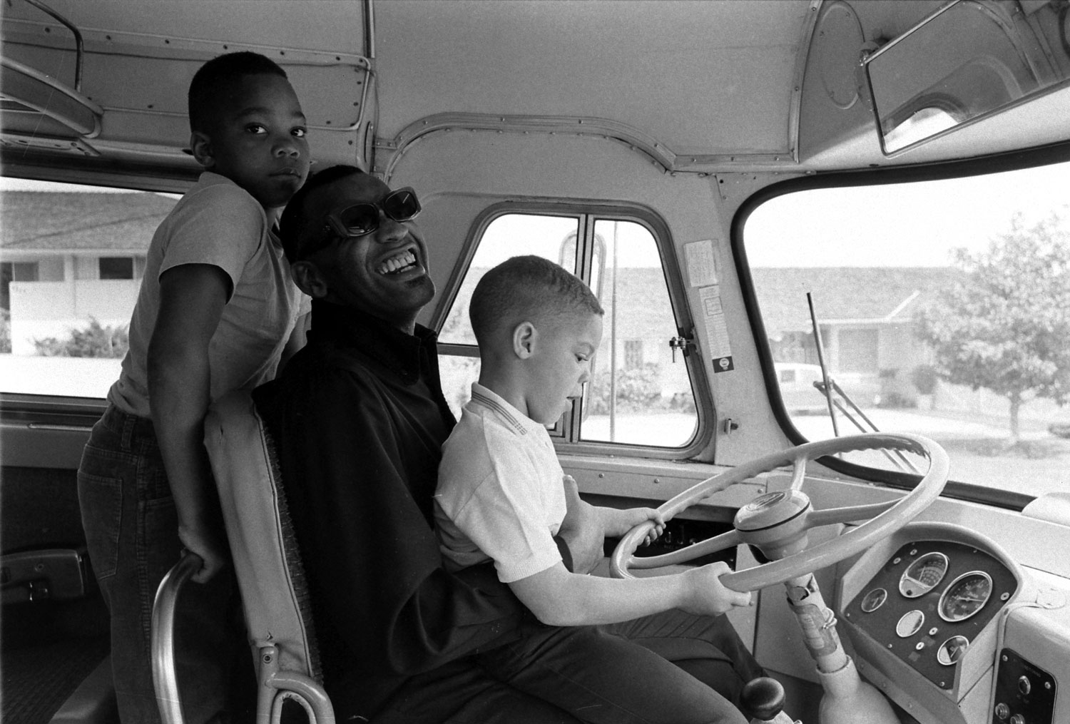 Ray Charles and his sons goof around on his tour bus, 1966.