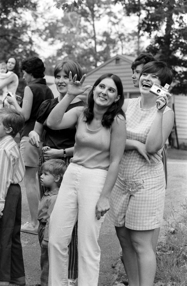 Moms wave to their kids at a school bus stop, New Jersey, 1971