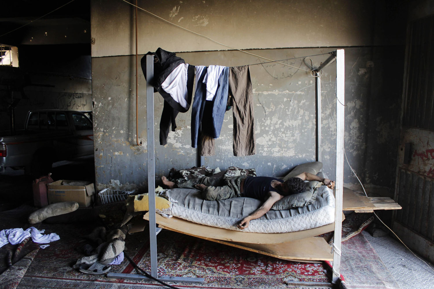 A Free Syrian Army fighter takes a rest in a safe house beside the Canadian Hospital in Aleppo