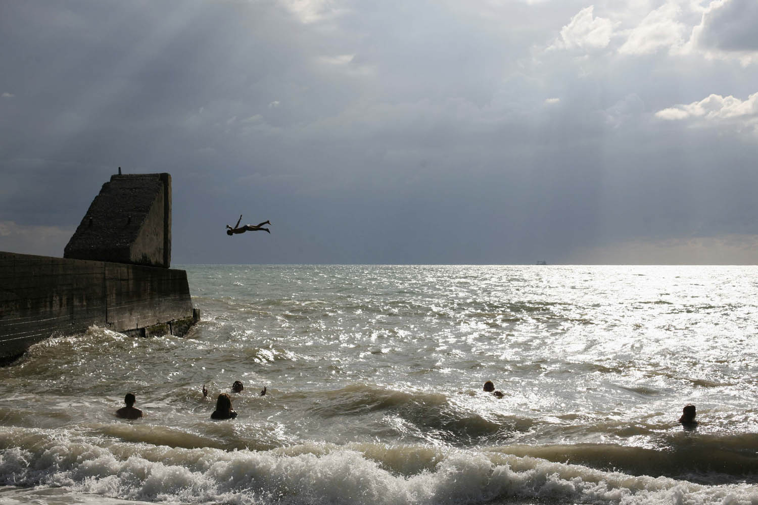 People swim and dive in the Black Sea at the south Russian coastal resort of Sochi