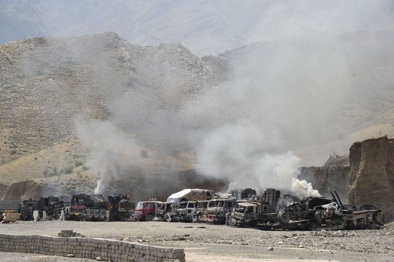 Smoke rises from burning NATO supply trucks after a Taliban attack at Torkham district