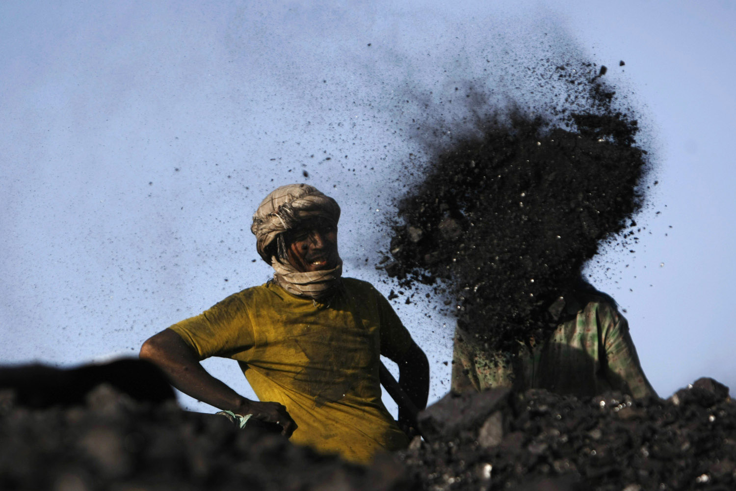 Labourers work at a coal dump site outside Kabul