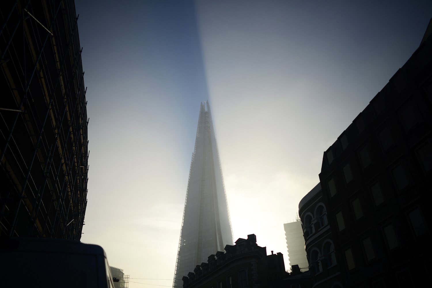 The early morning sun hits The Shard building as fog clears over  London