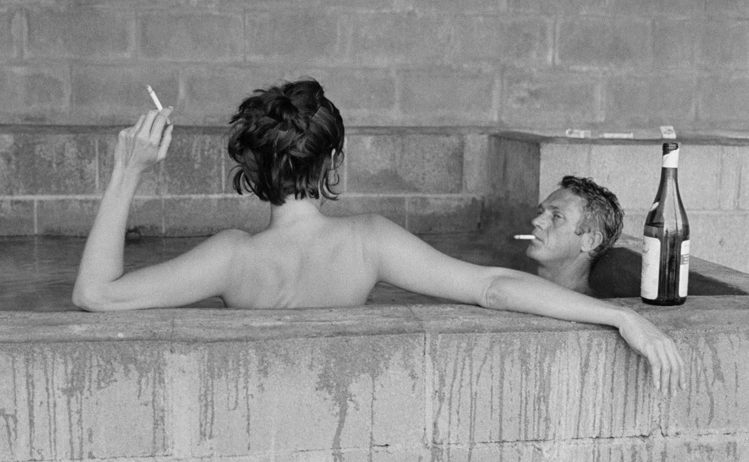 Steve McQueen and his wife, Neile, take a sulphur bath at Big Sur, 1963.