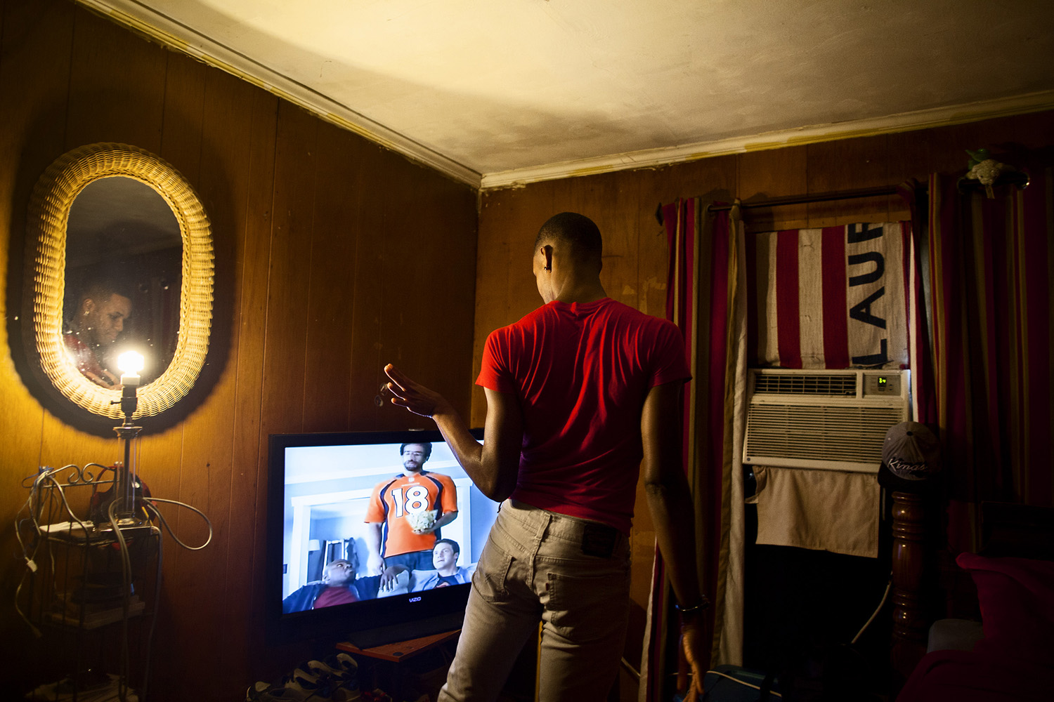 Adrian watches a TV commercial in his bedroom in his mother's house. Several of the members of the line live at home with relatives. Among their ranks, a number have faced considerable difficulty when dealing with family members' reactions to their orientation. The Prancing Elites are a group of young, gay, black men who practice J-Sette, a form of dance birthed at Historically Black Colleges that is characterized by sharp, cheerleading-style movements and hip-hop performed to an eight-count beat. Traditionally, men cannot join college dance teams, so young gay black men have been forming their own J-Sette "lines," organizing competitions, and creating their own outlets to practice this type of dance.