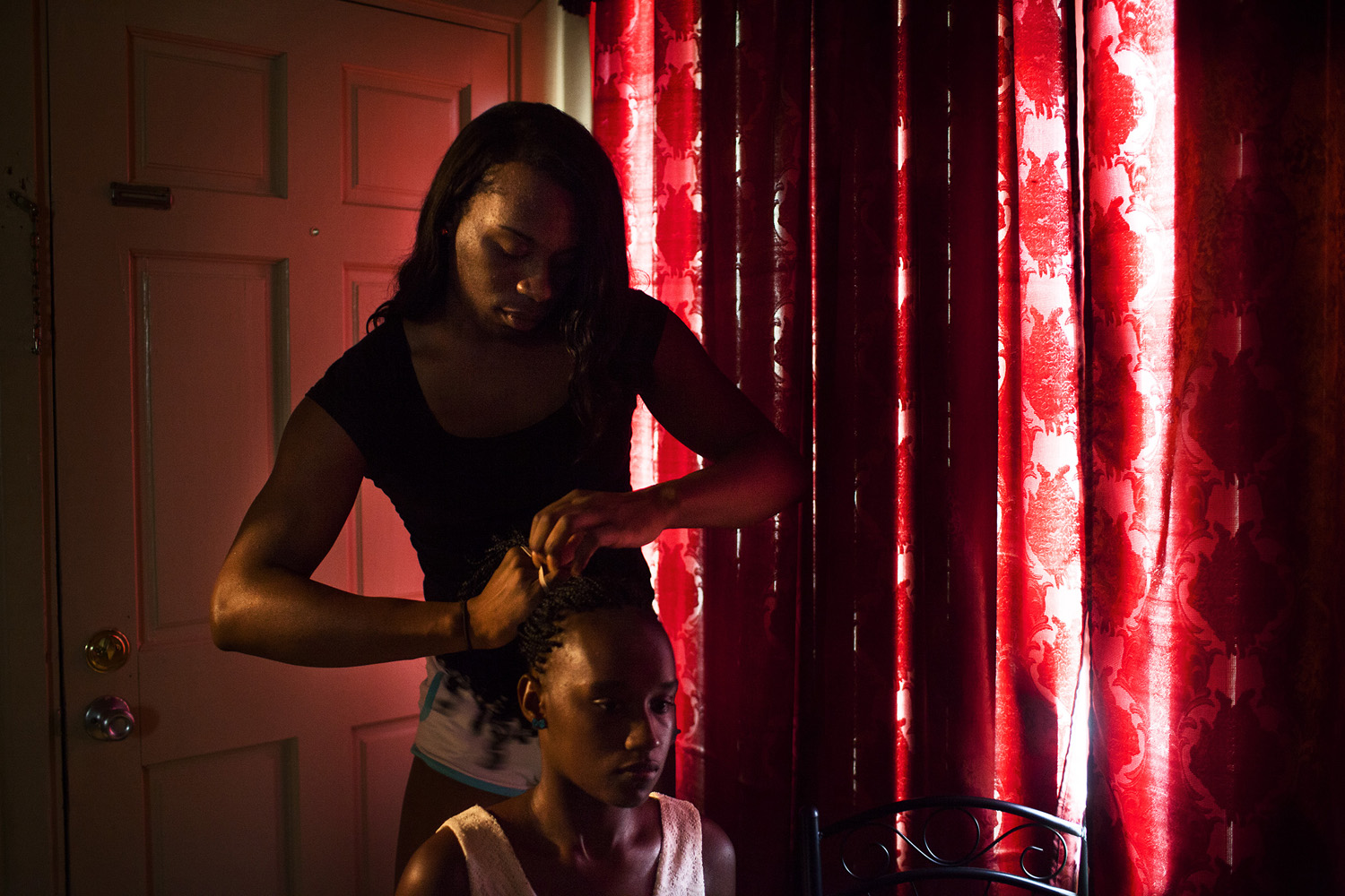 Tamara, who was born Timothy, braids her boyfriend's cousin's hair. Tamara is transgender, and has been living with her boyfriend and his sister since being kicked out of her mother's home by her mother's boyfriend. The Prancing Elites are a group of young, gay, black men who practice J-Sette, a form of dance birthed at Historically Black Colleges that is characterized by sharp, cheerleading-style movements and hip-hop performed to an eight-count beat. Traditionally, men cannot join college dance teams, so young gay black men have been forming their own J-Sette "lines," organizing competitions, and creating their own outlets to practice this type of dance.