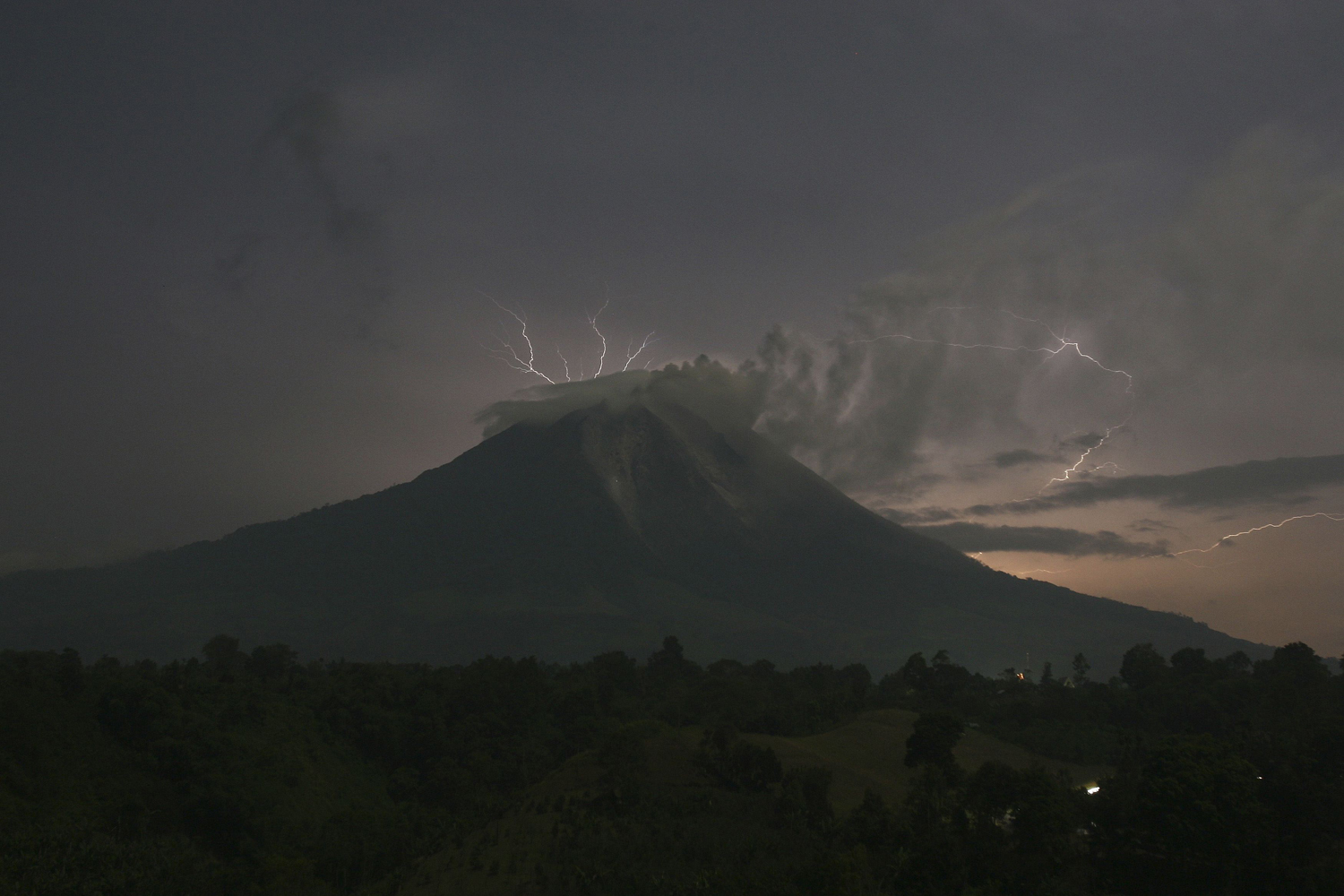 Lightning strikes as Mount Sinabung spews ash and hot lava, at Simpang Empat village in Karo district