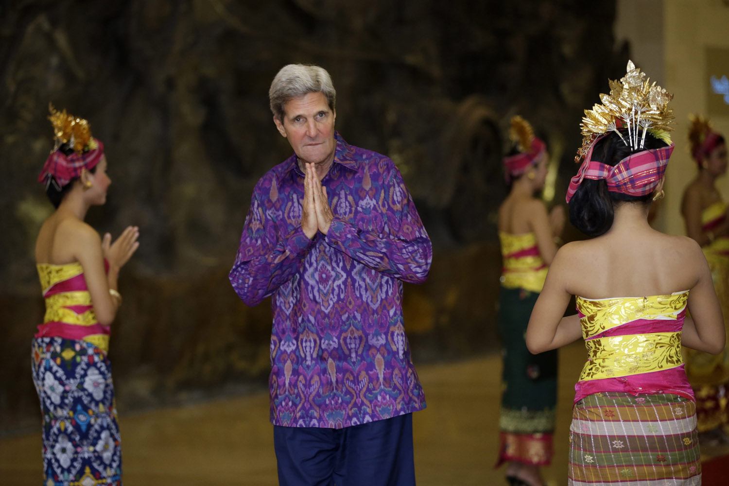 Oct. 7, 2013. U.S. Secretary of State John Kerry, wearing 'endek', a traditional Balinese woven fabric, poses upon arrival for a dinner for leaders of the Asia-Pacific Economic Cooperation (APEC) forum in Bali, Indonesia.