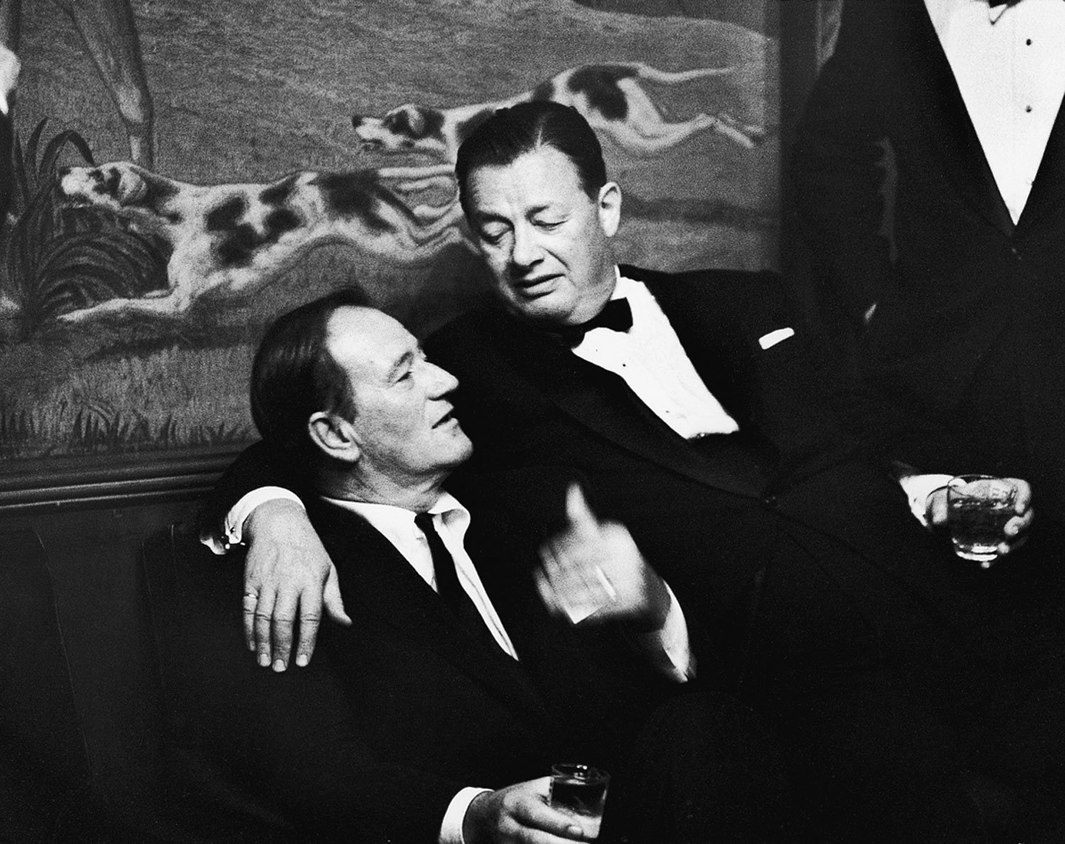 Legendary saloonkeeper Toots Shor (right) with John Wayne on closing night at Shor's famous New York watering hole, 1959.