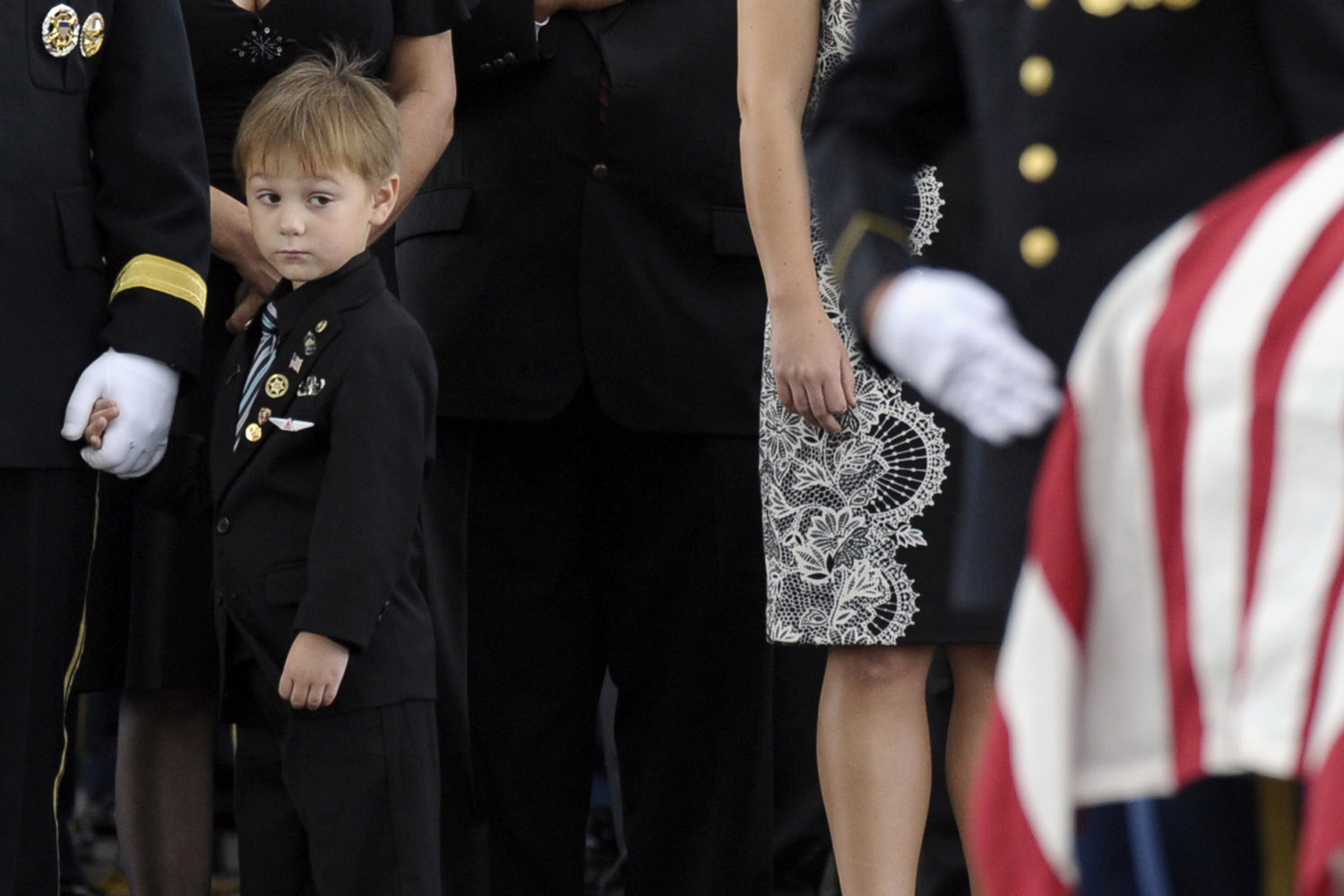 Sept. 27, 2013. Kaden Bowden, son of U.S. Army Staff Sgt. Joshua J. Bowden, looks at the casket for his father during burial services for Staff Sgt. Bowden at Arlington National Cemetery in Arlington, Va.