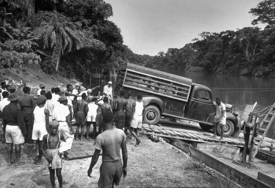 Loading a truck onto a ferry to cross a river, French Equatorial Africa, 1951.