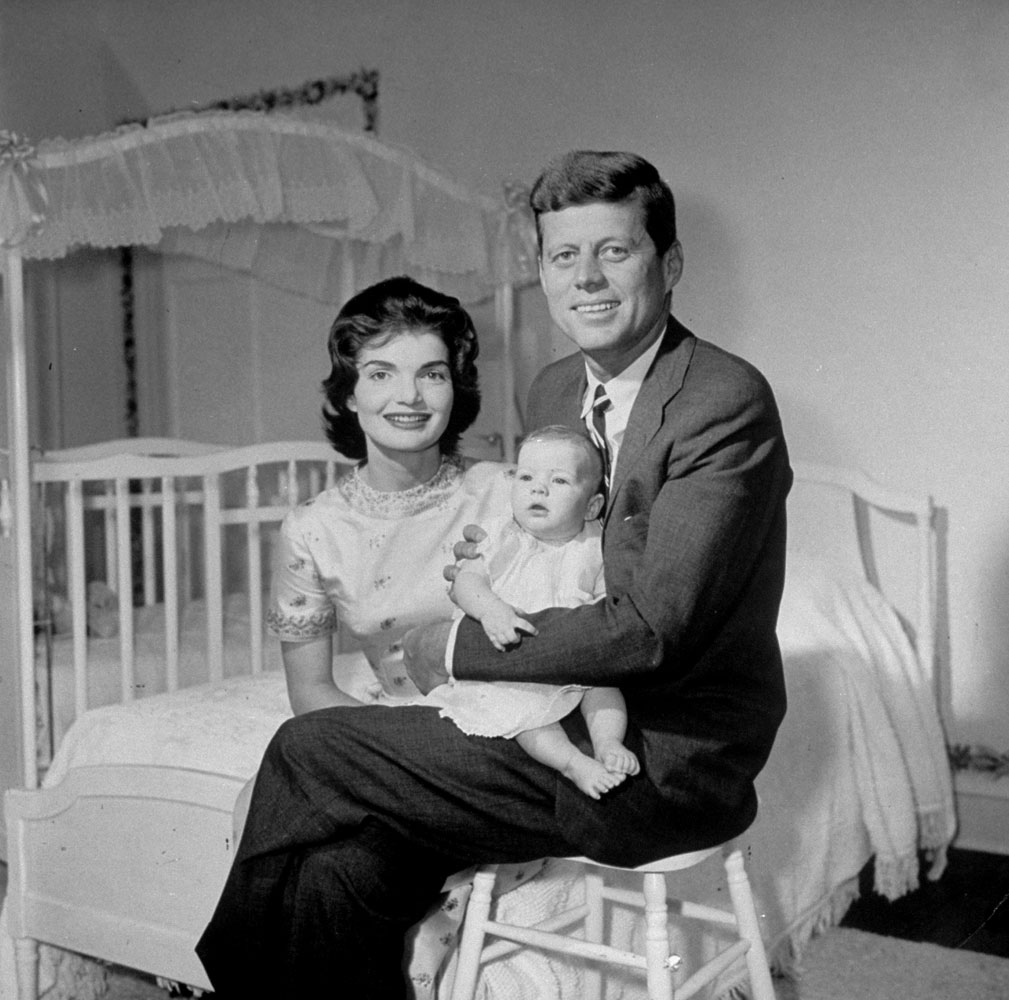 John and Jackie Kennedy with their baby daughter, Caroline, in their Georgetown home, 1958.