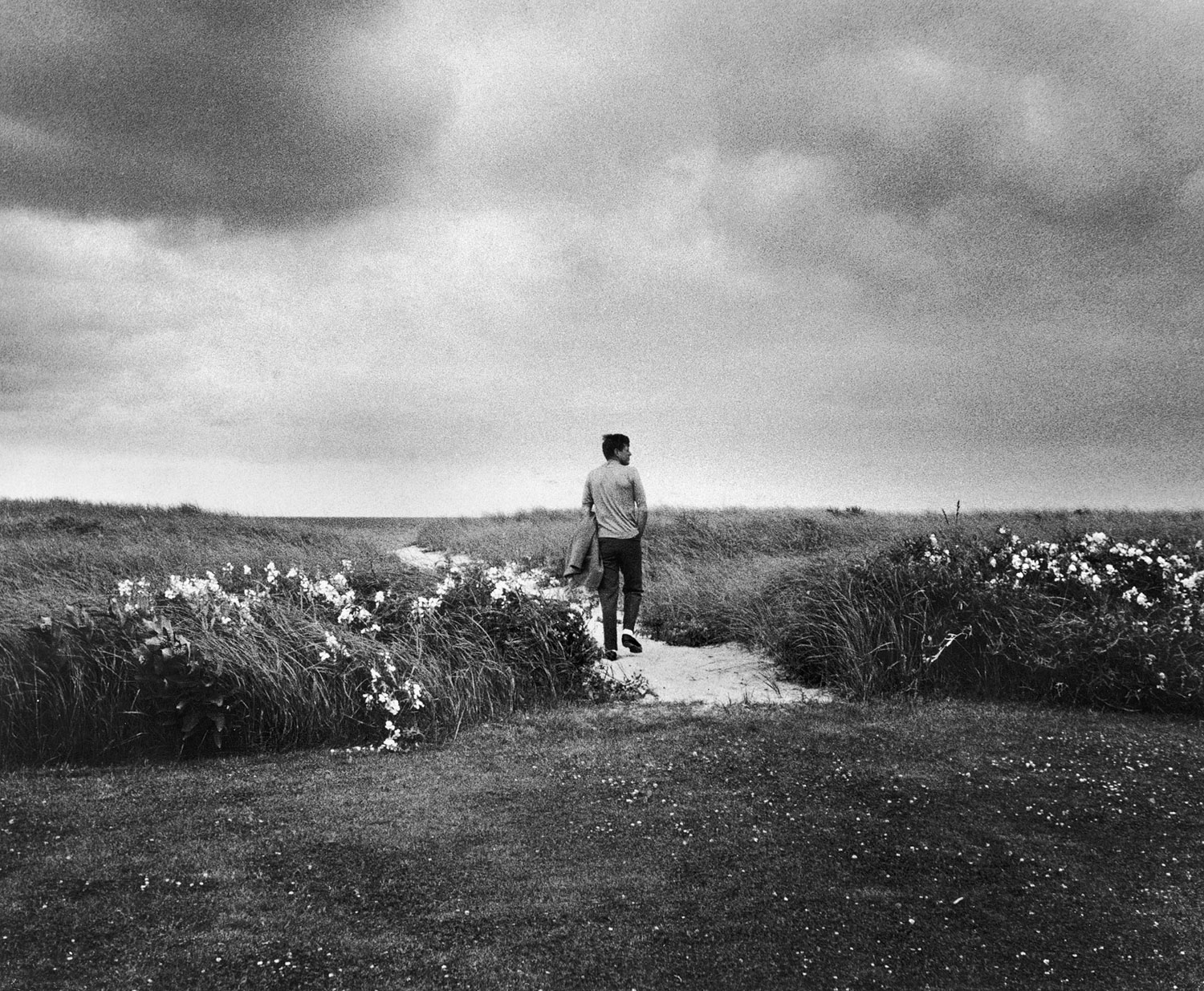 In a picture that he later called his favorite photo of himself, Senator John F. Kennedy walks the dunes near Hyannis Port, Mass., 1959.
