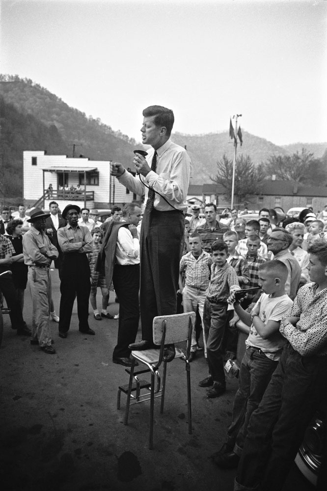 John F. Kennedy gives a speech while standing on a kitchen chair in West Virginia's coal country, 1960.