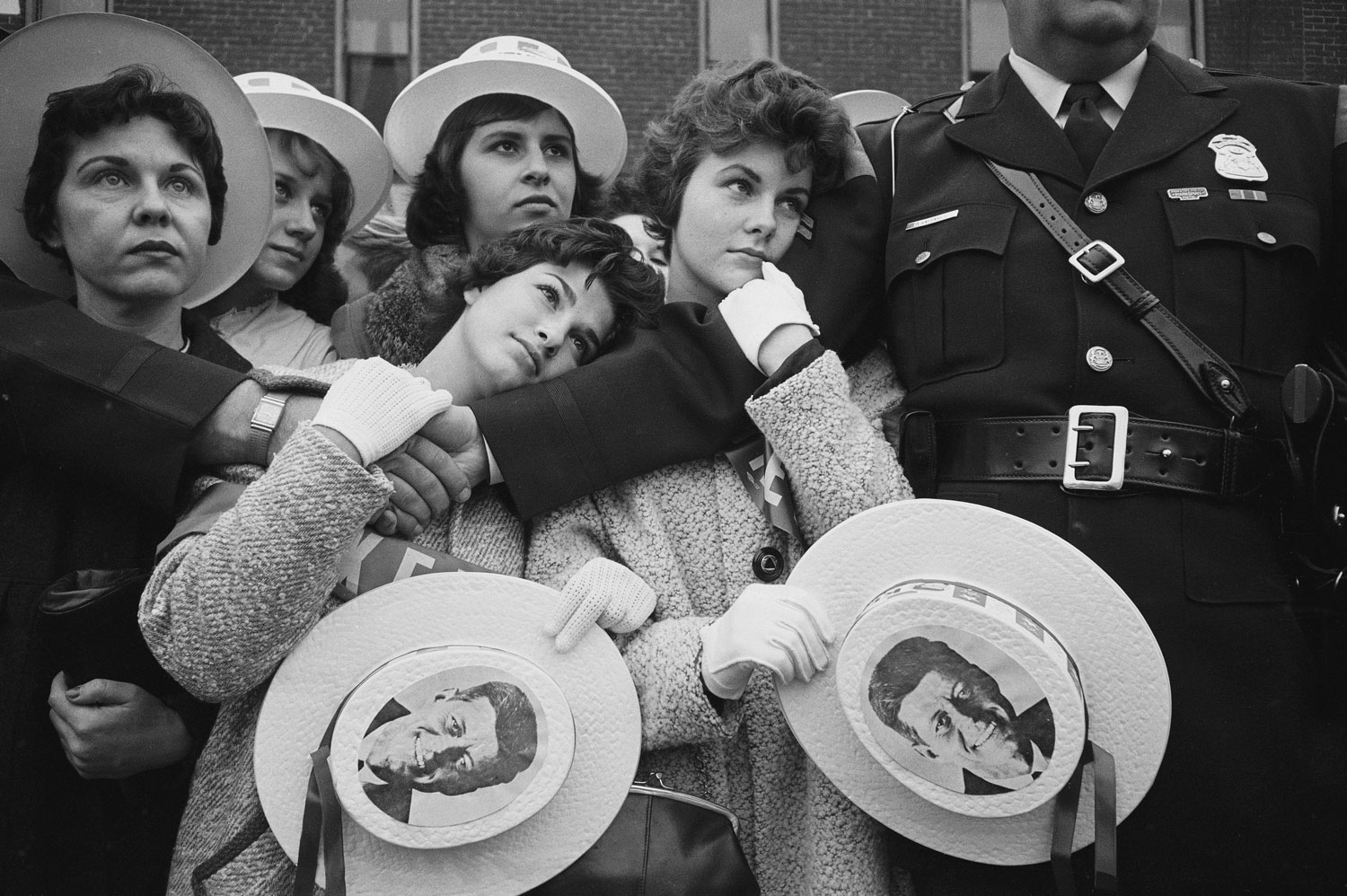 Young female supporters of Sen. John F. Kennedy await his arrival at a campaign appearance in Michigan, 1960.